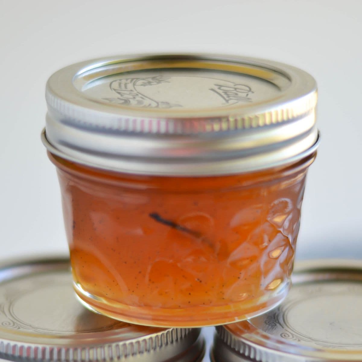 Peach Vanilla Jam in a 4 oz canning jar.