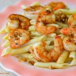 a serving of Blackened Shrimp Scampi served over pasta on a plate