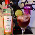 Red Moscato Cocktail in a wine glass with lime wedge for Halloween