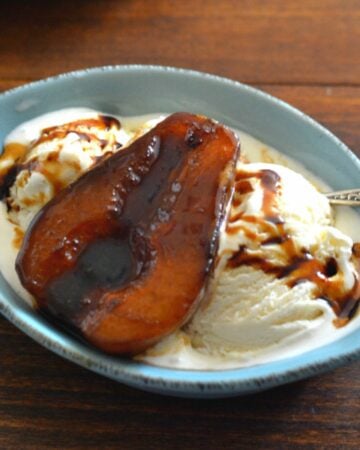 Balsamic Poached Peach served over vanilla ice cream in a bowl.