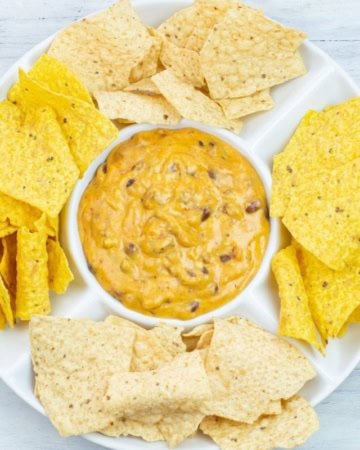 Cheesy Dip in a chip and dip serving plate.