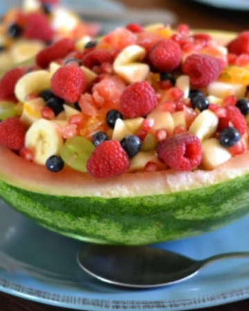Pomegranate Fruit Salad served in a half watermelon.