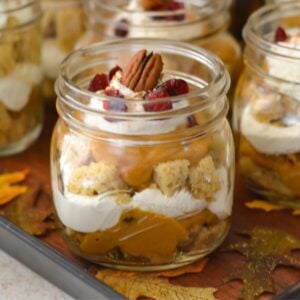 Pumpkin Cranberry Trifle served in a mason jar on a serving tray.