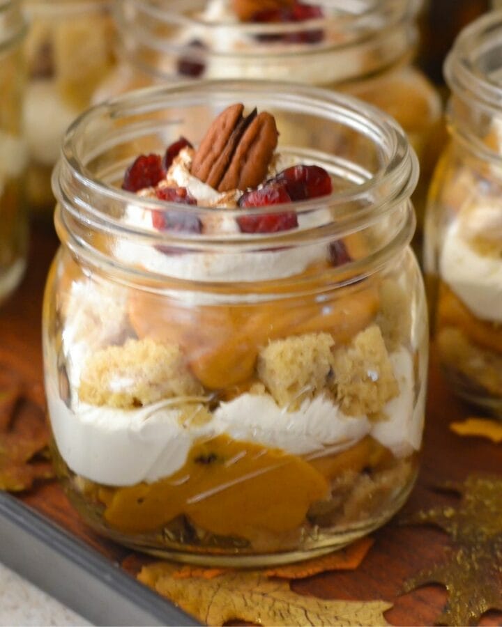 Pumpkin Cranberry Trifle served in a mason jar on a serving tray.