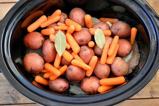 Making a London Broil with potatoes and carrots in a crock pot