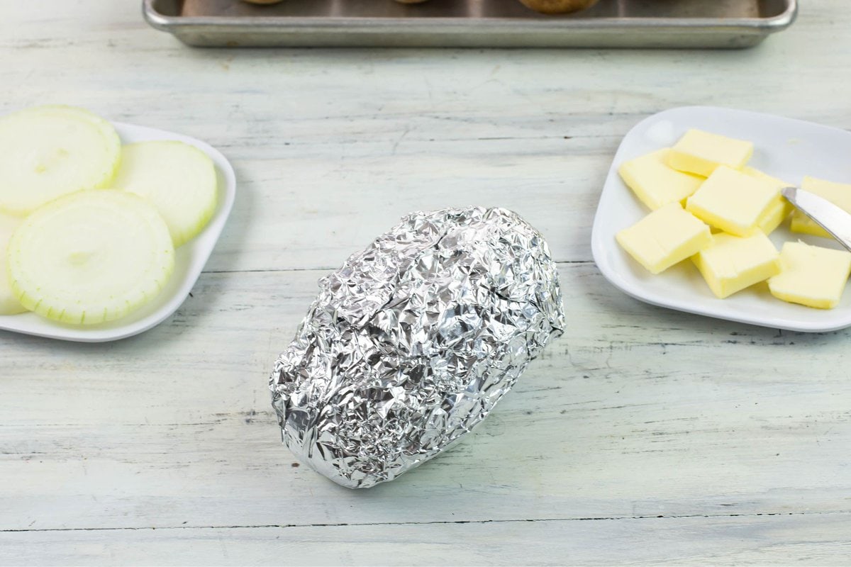 A potato tightly wrapped in foil.