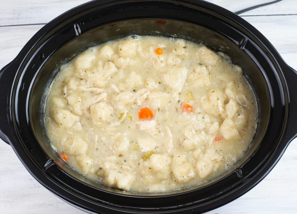 overhead photo of the slow cooker chicken and dumplings recipe after the dumplings have cooked and floated to the top of the broth