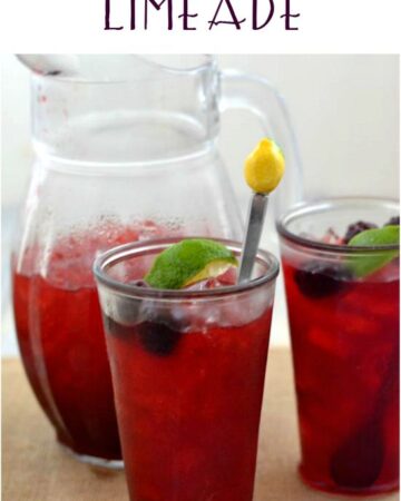 Blackberry Iced Cooler in glass with a pitcher beside.