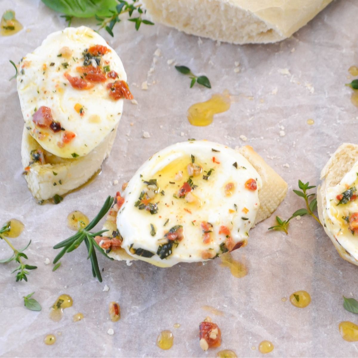 Slices of marinated mozarella cheese on slices of bread.