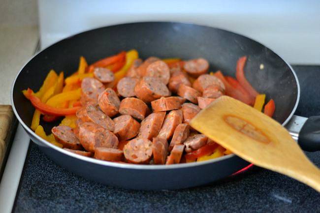 Cooking Italian Sausage and bell peppers for an easy skillet pasta recipe via flouronmyface.com