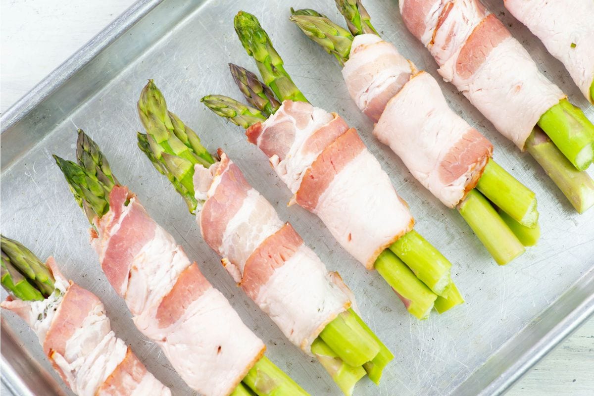 Close up over head image of asparagus wrapped in bacon.