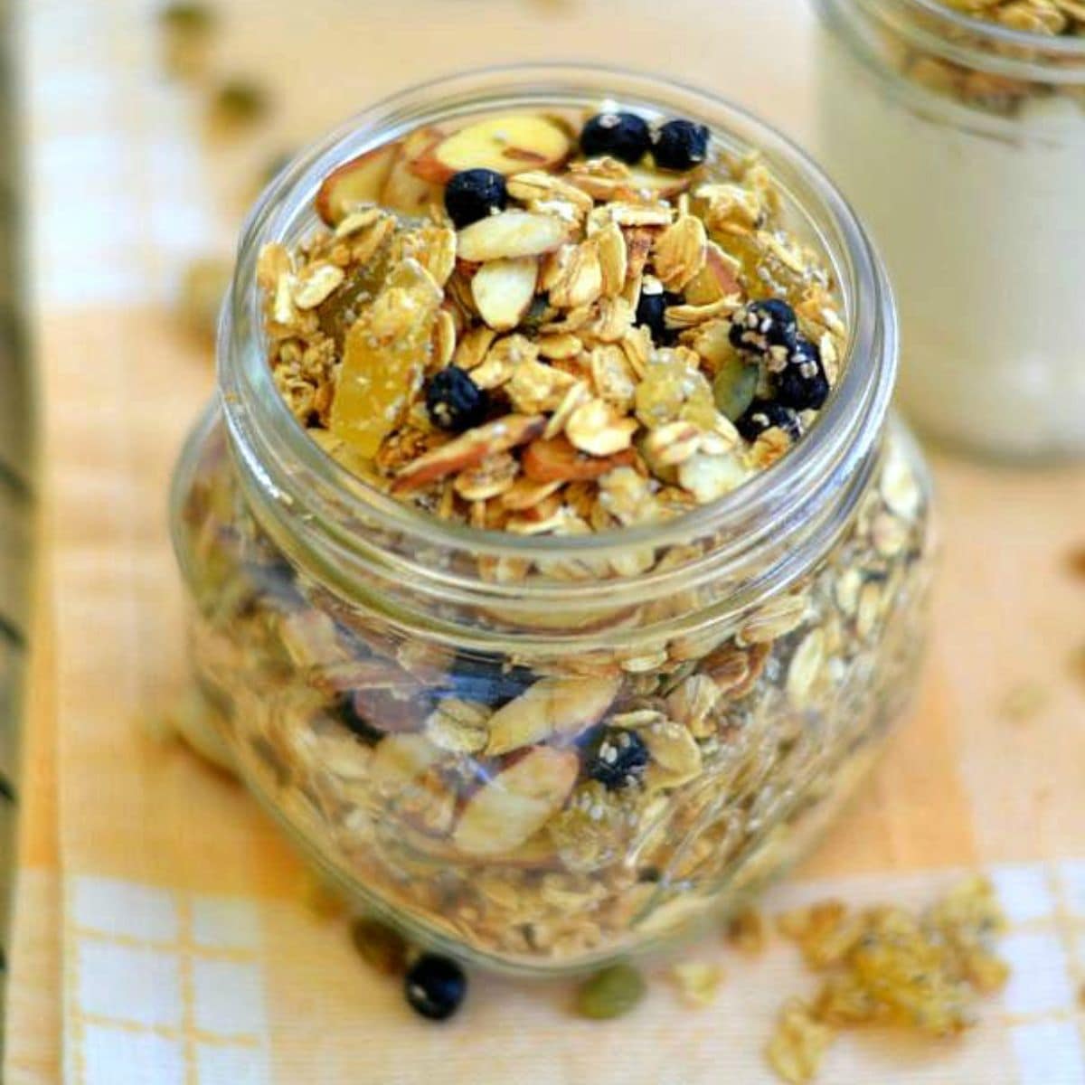Glass jar filled with homemade pineapple blueberry granola.