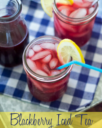 Blackberry Iced Tea in a glass with lemon wedge.