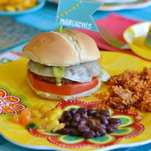 Chimichurri Burger on a plate with sides.