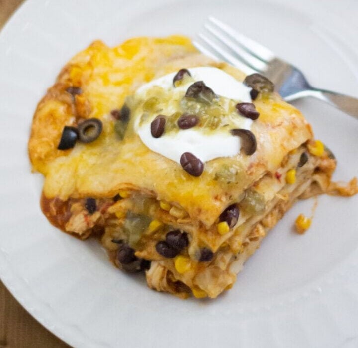 A square piece of Chicken Enchilada Casserole on a plate.