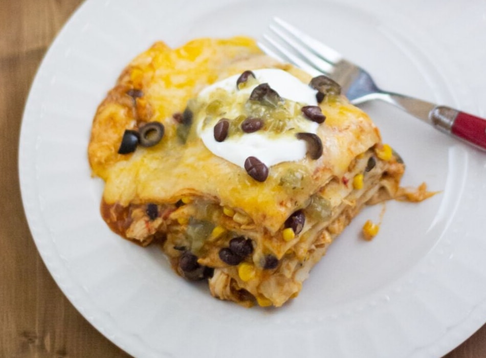 A square piece of Chicken Enchilada Casserole on a plate.
