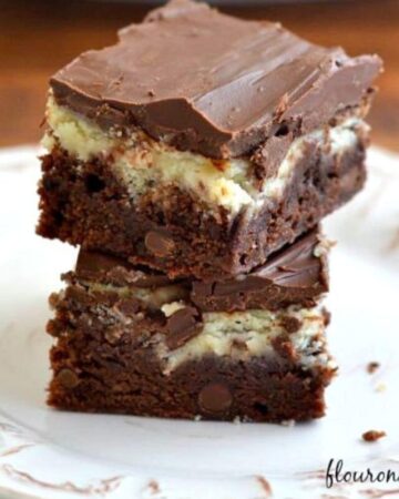 Cheesecake Brownie Bars stacked on a dessert plate.