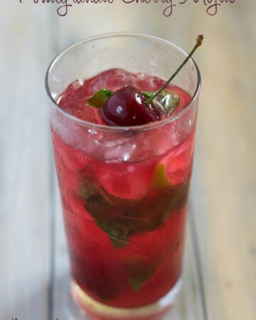 Pomegranate Cherry Mojito in a tall glass.