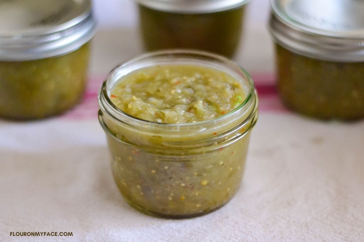 Homemade salsa verde in an open canning jar.