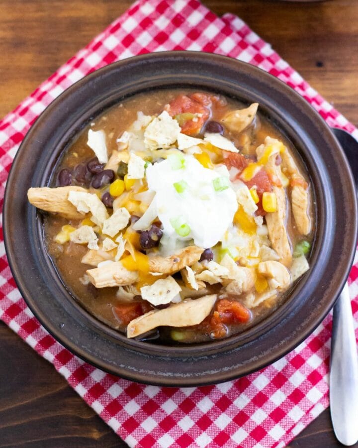 Chicken Tortilla soup in a bowl with a cloth napkin.