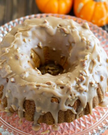 Overhead view of Pumpkin Pecan Bundt cake served on a vintage glass cake stand.