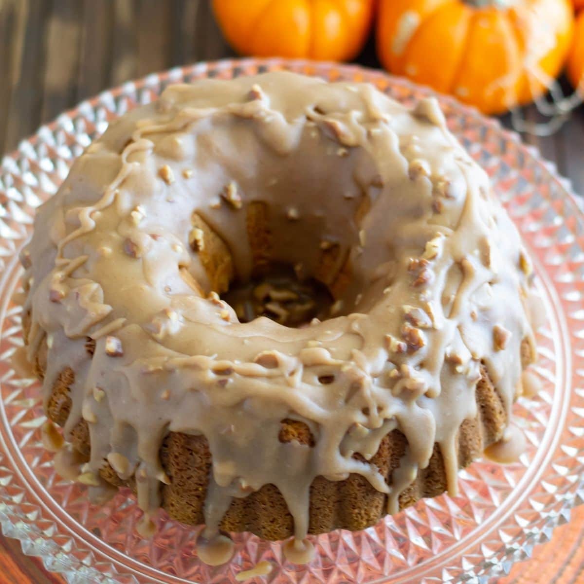 Overhead view of Pumpkin Pecan Bundt cake served on a vintage glass cake stand.