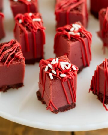 Squares of Red Velvet Fudge on a cake stand.