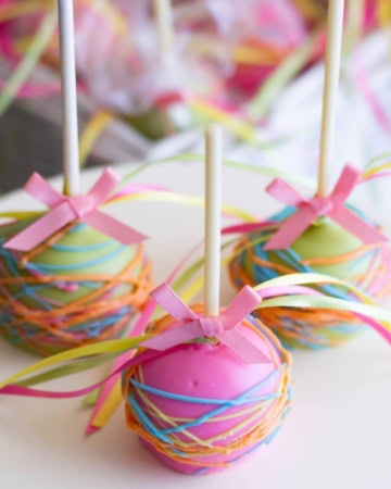 Paisley baby shower themed cake pops on a cake stand.