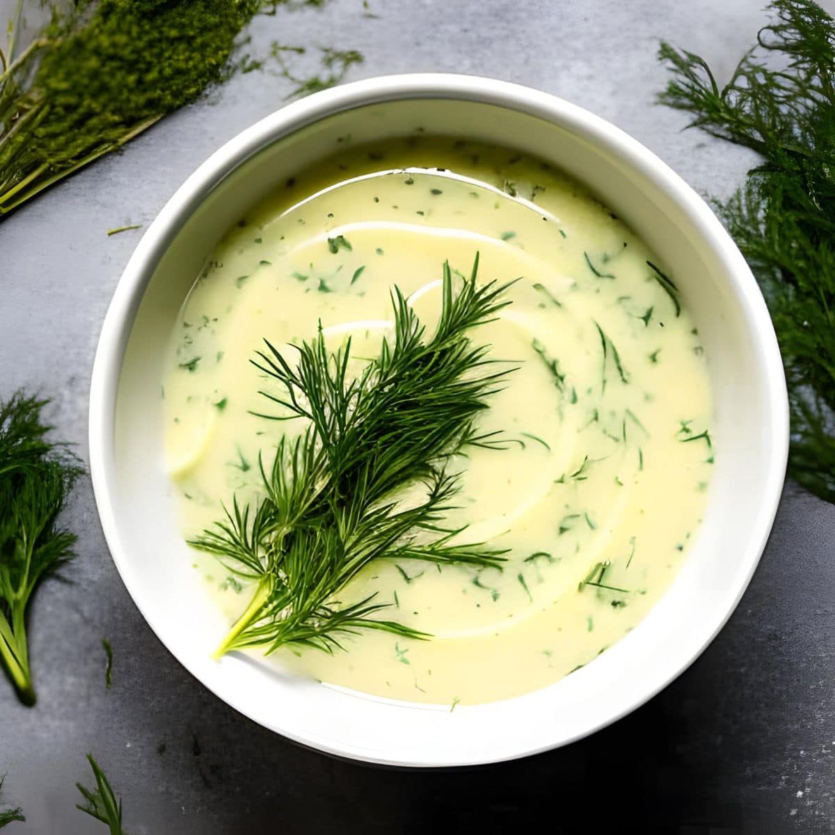 A small bowl of homemade dill butter.