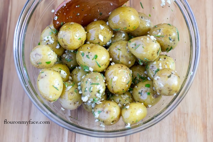 Baby potatoes tossed with olive oil, minced garlic, fresh rosemary and fresh parsley via flouronmyface.com
