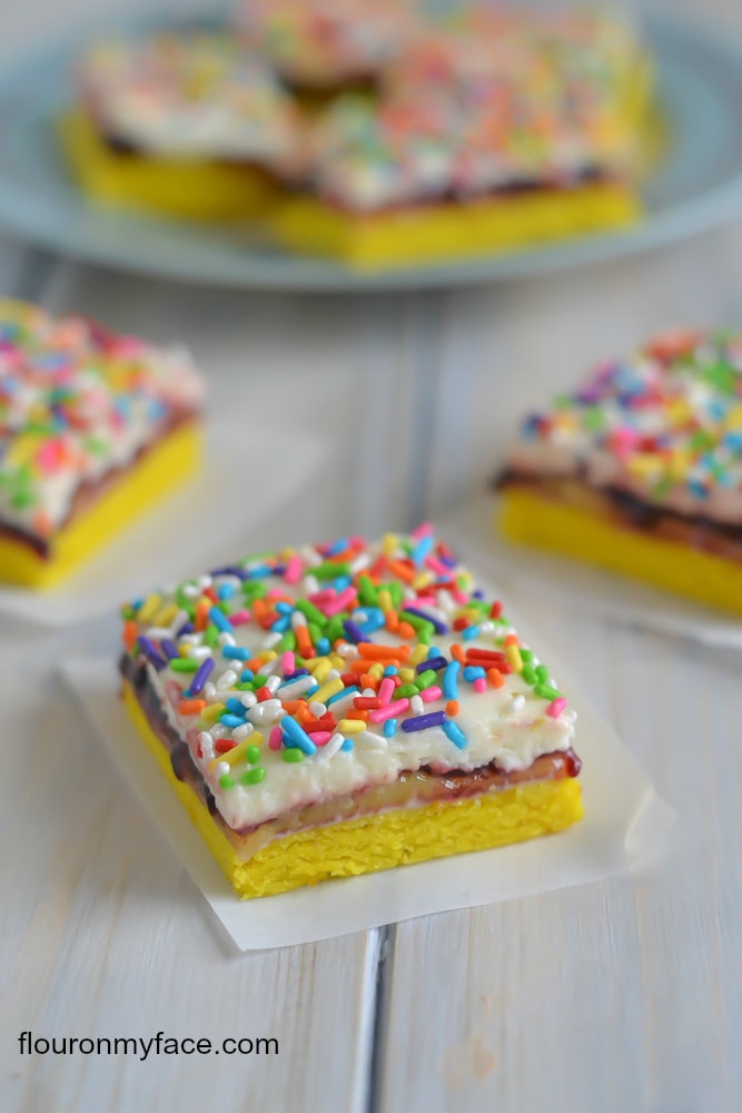 Make these Lemon Blueberry Funfetti Cakes Bars for any occasion. They would be perfect cake bars for a Spring time tea party or dessert via flouronmyface.com