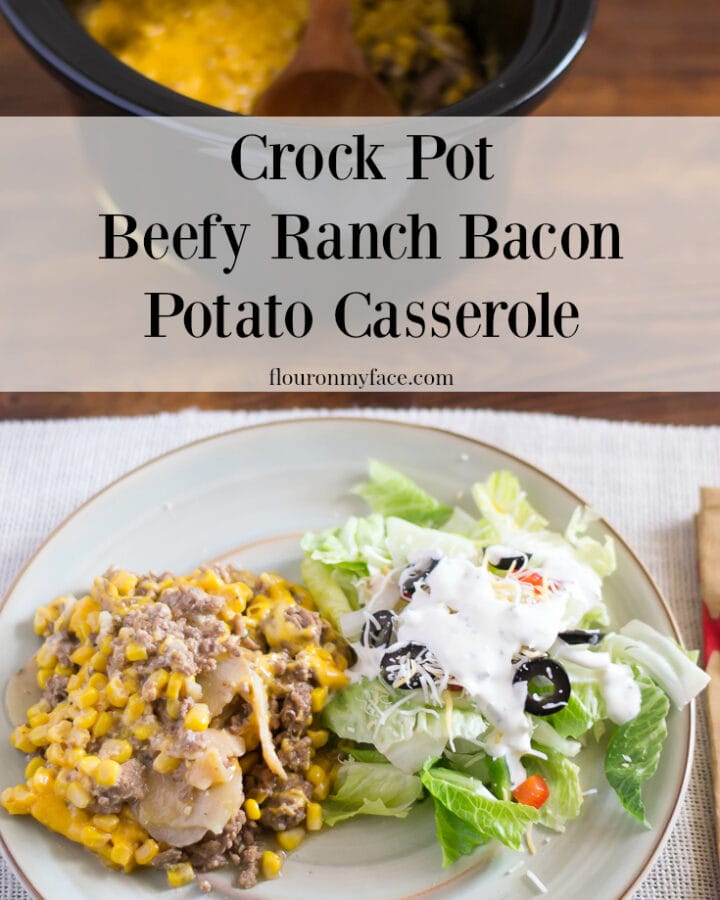 Crock Pot Beefy Ranch Potatoe Casserole recipe on a plate served with a salad.