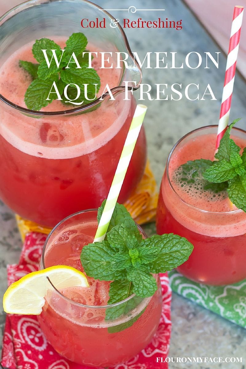 Glass pitcher with glasses filled with Watermelon Aqua Fresca.