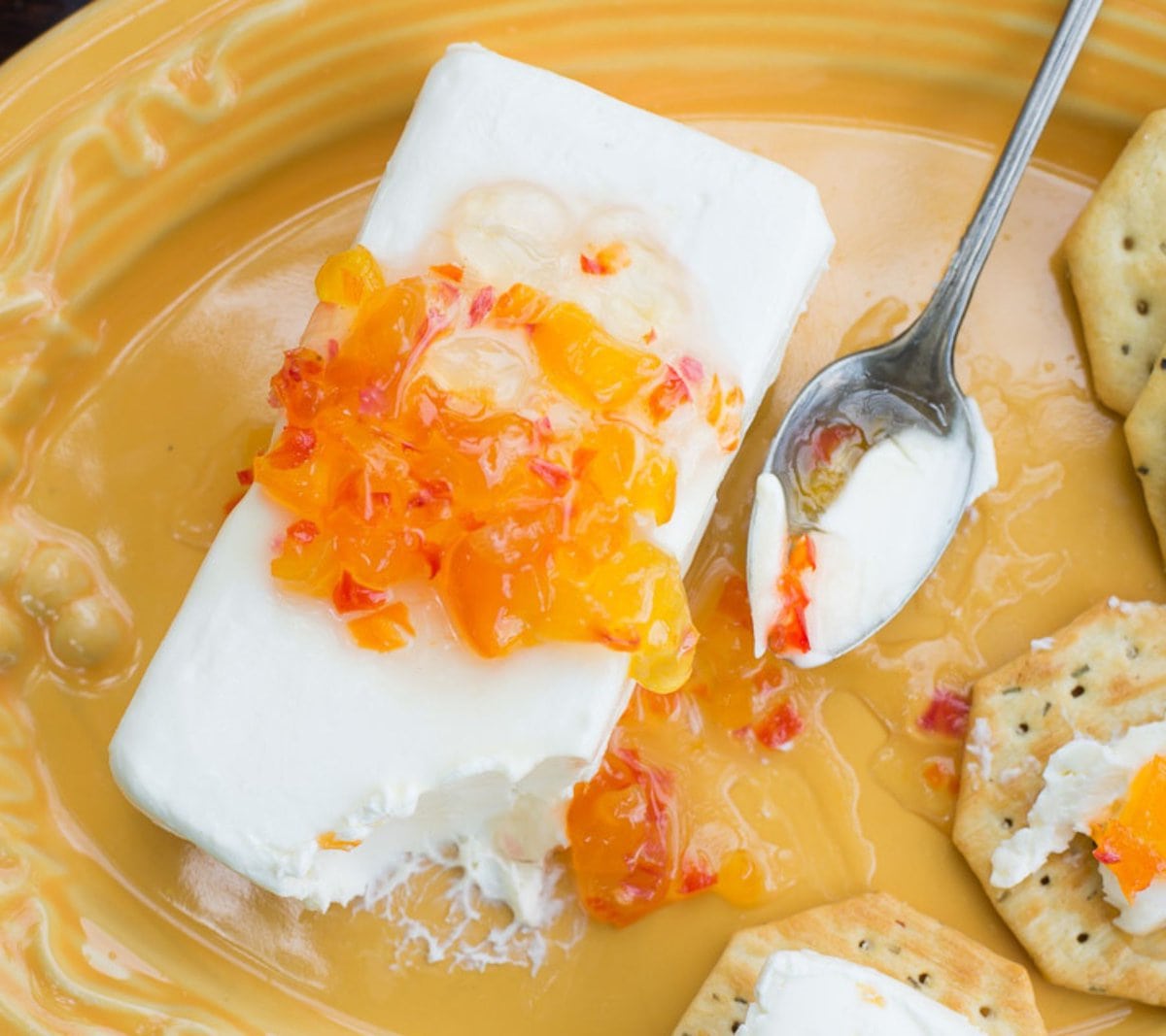 Habanero Jelly poured over a block of cream cheese with crackers.