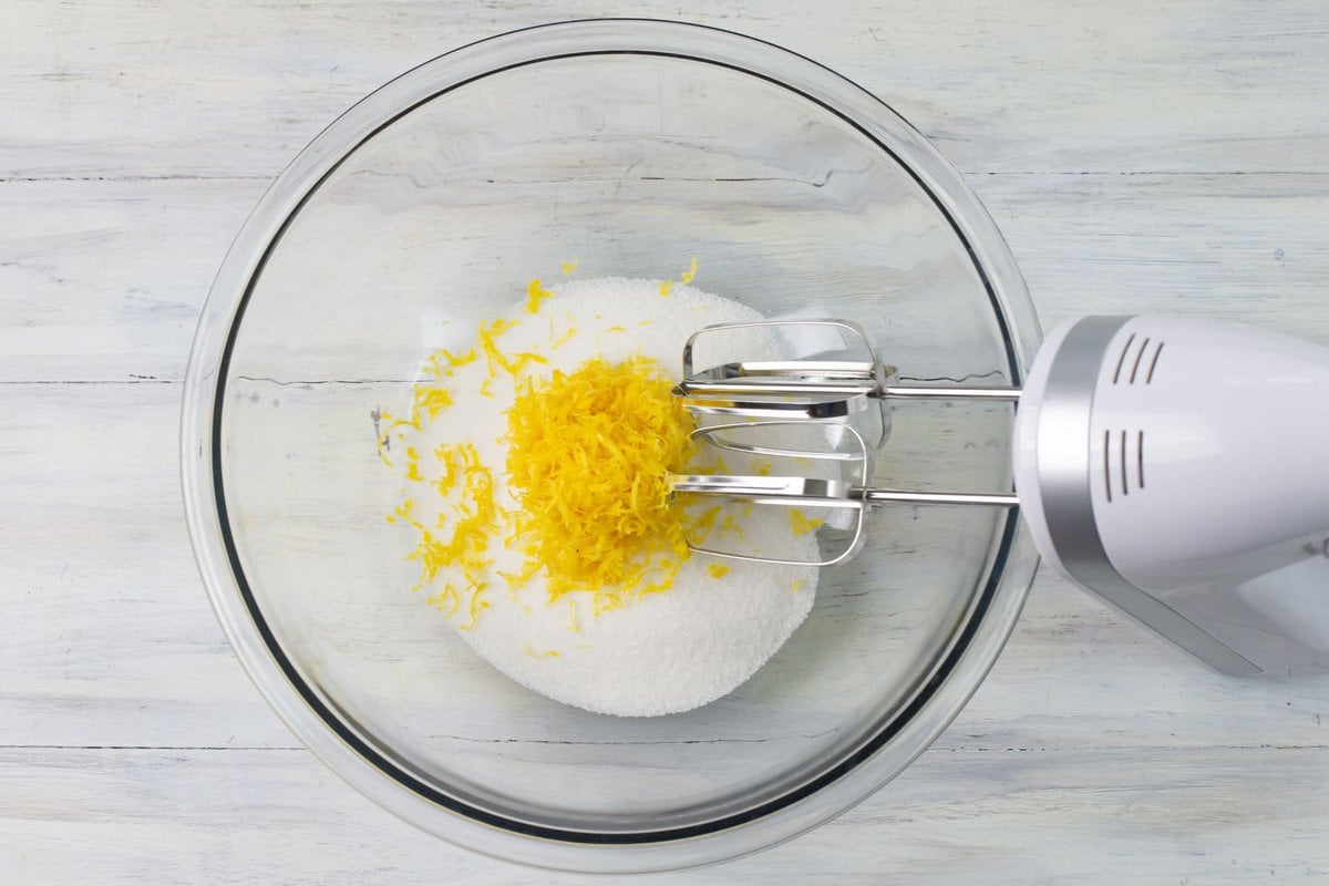 White sugar with lemon zest in a bowl.