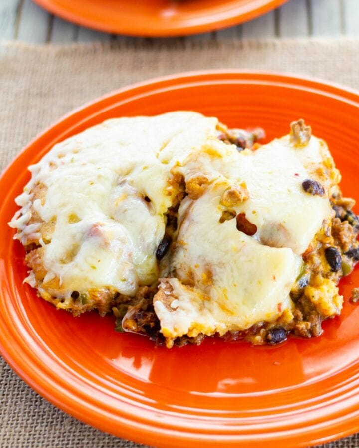 A serving of Taco Pie on a orange plate.