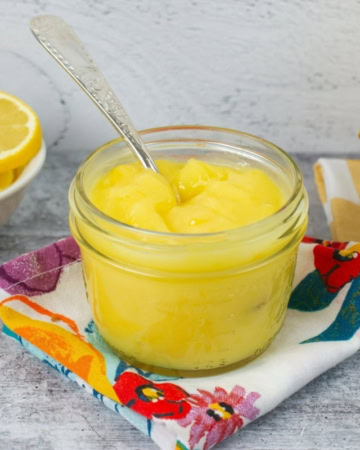 Homemade lemon curd in a glass jar.