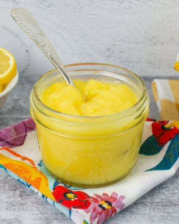Homemade lemon curd in a glass jar.