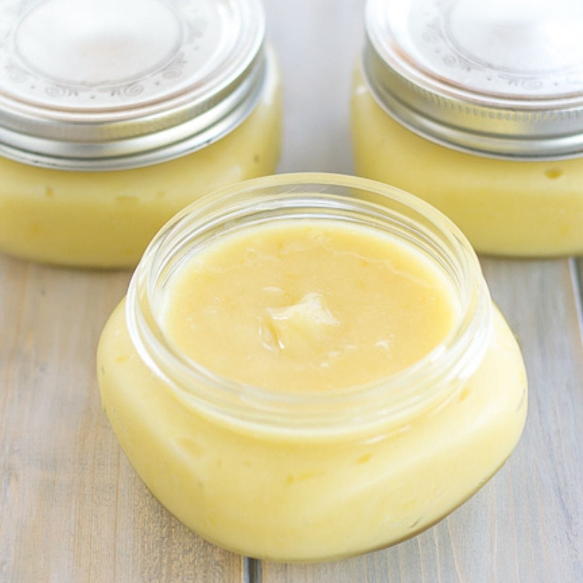 Homemade lemon curd in a glass jar.