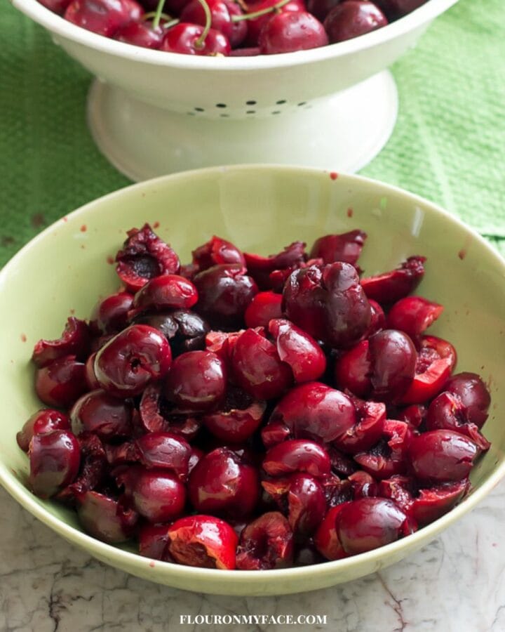 A bowl filled with pitted cherries.