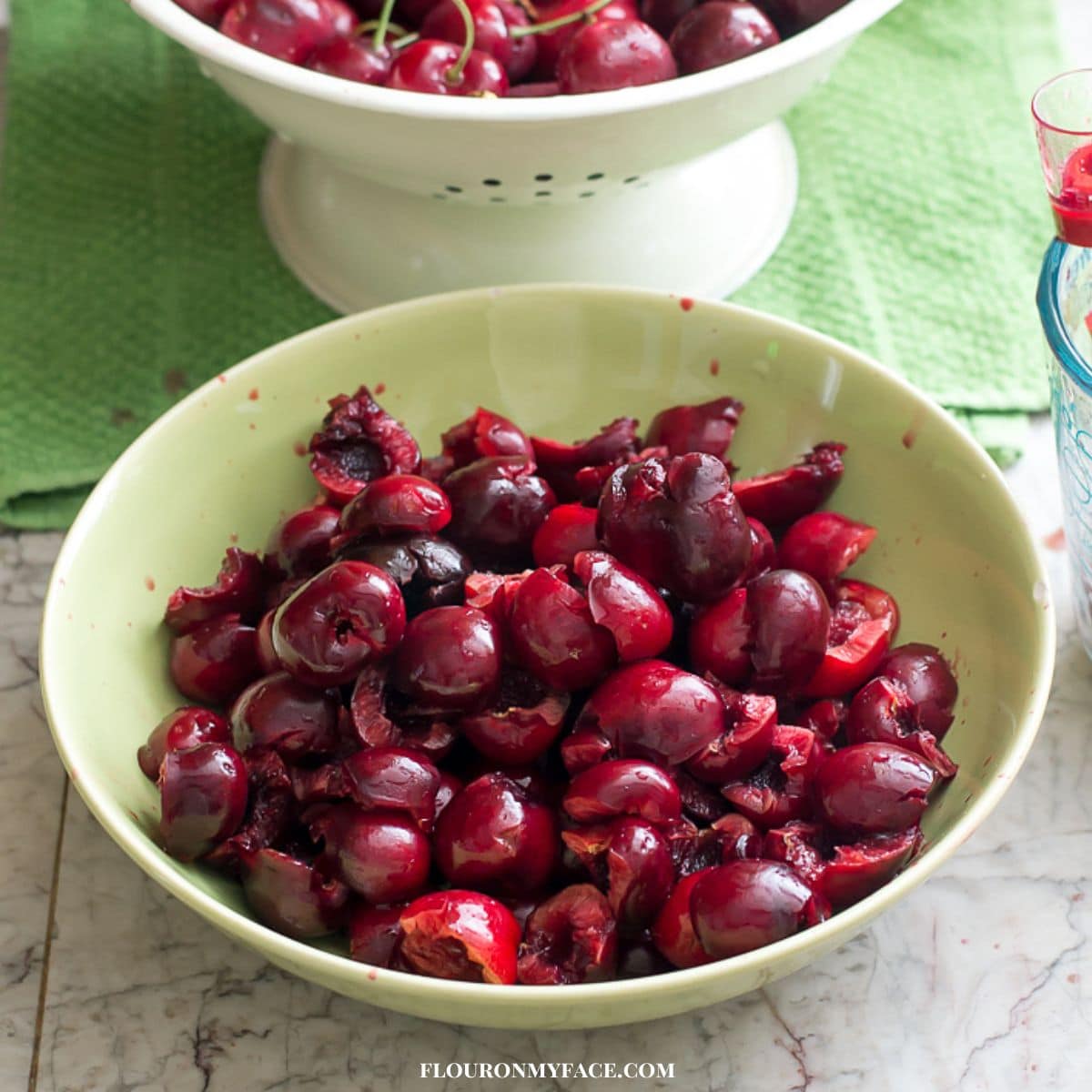 A bowl filled with pitted cherries.