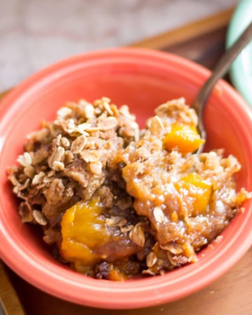 A bowl of Peach Crunch Dump Cake.