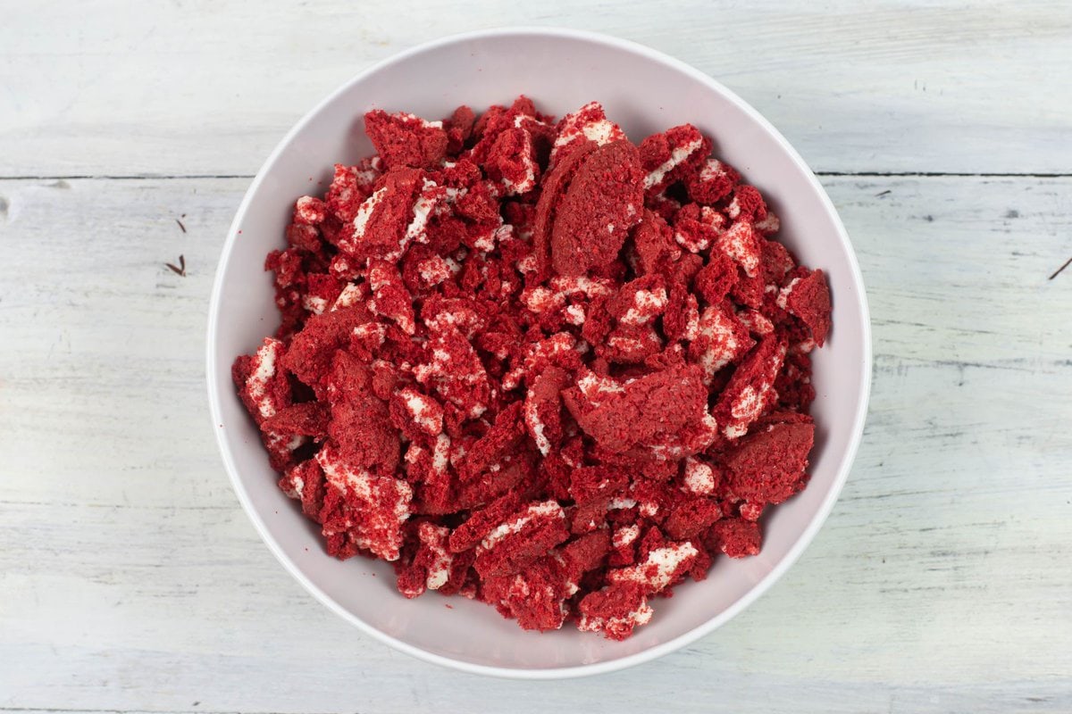 Crushed red velvet sandwich cookies in a large bowl.