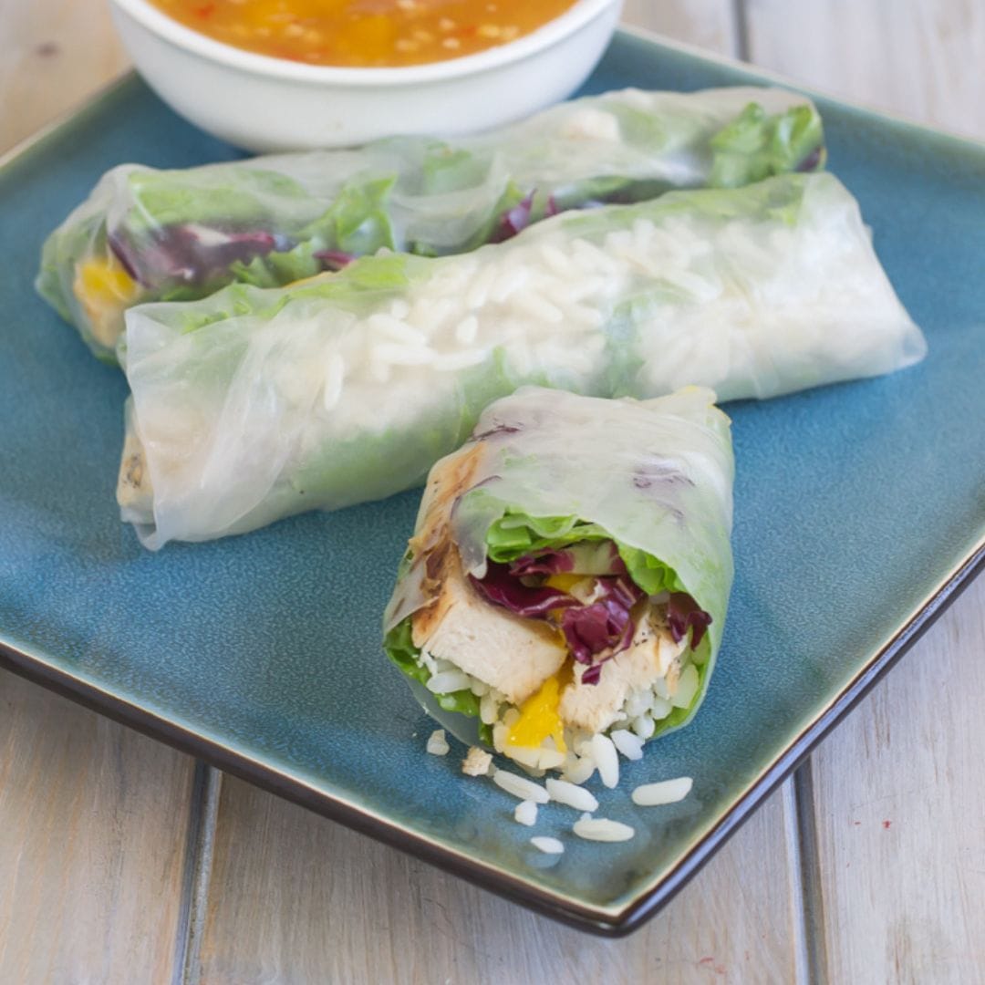 Chicken Mango Fresh Spring Rolls served with mango chili sauce on a plate.