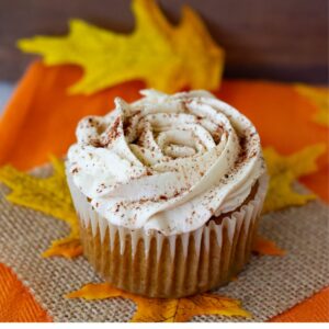One Pumpkin Spice Cupcake on a fall tabletop.