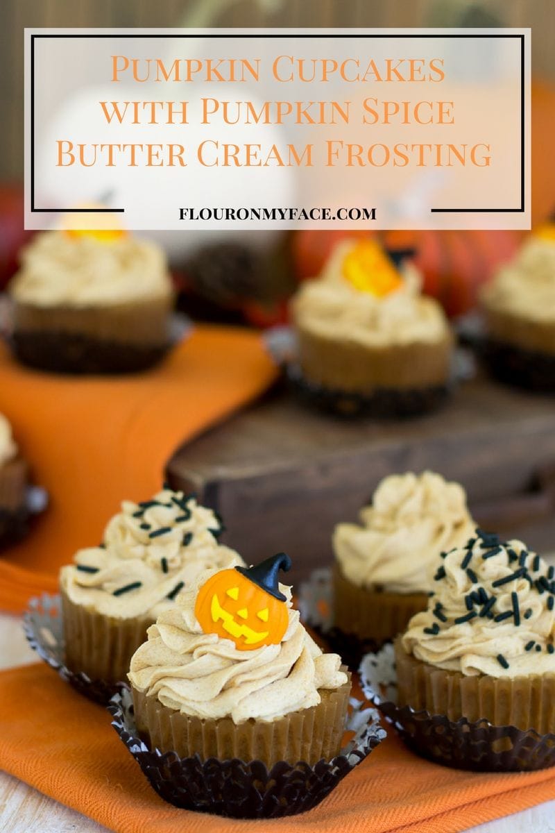 Homemade Pumpkin Cupcakes topped with Pumpkin Spice Butter Cream Frosting and decorated with black sprinkles for Fall. 
