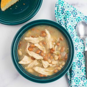 Teal colored bowl filled with white chicken chili.