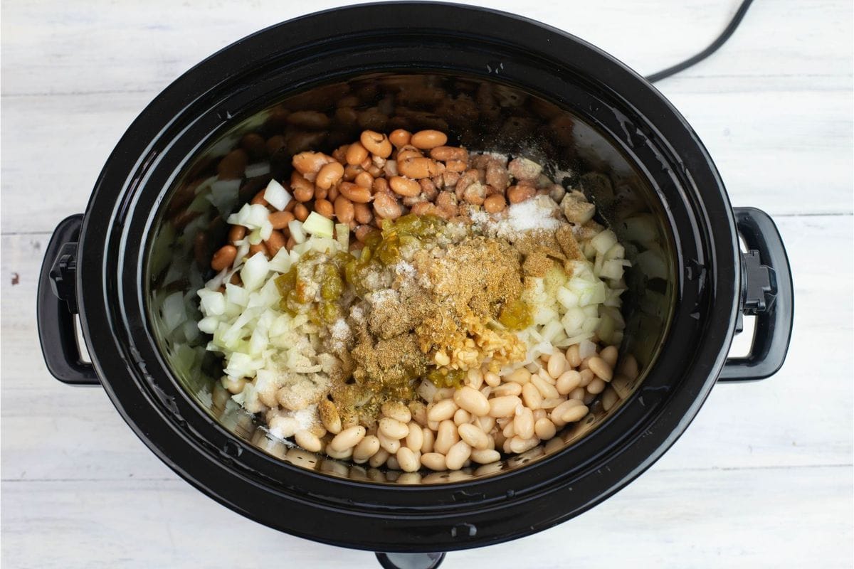Chicken chili ingredients in a slow cooker.
