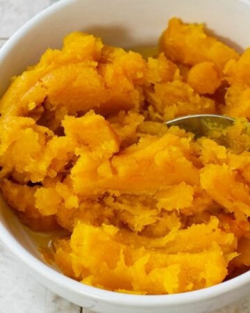A white bowl filled with homemade pumpkin puree.