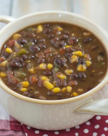 Black Bean and Corn Soup served in a white soup bowl with handles.